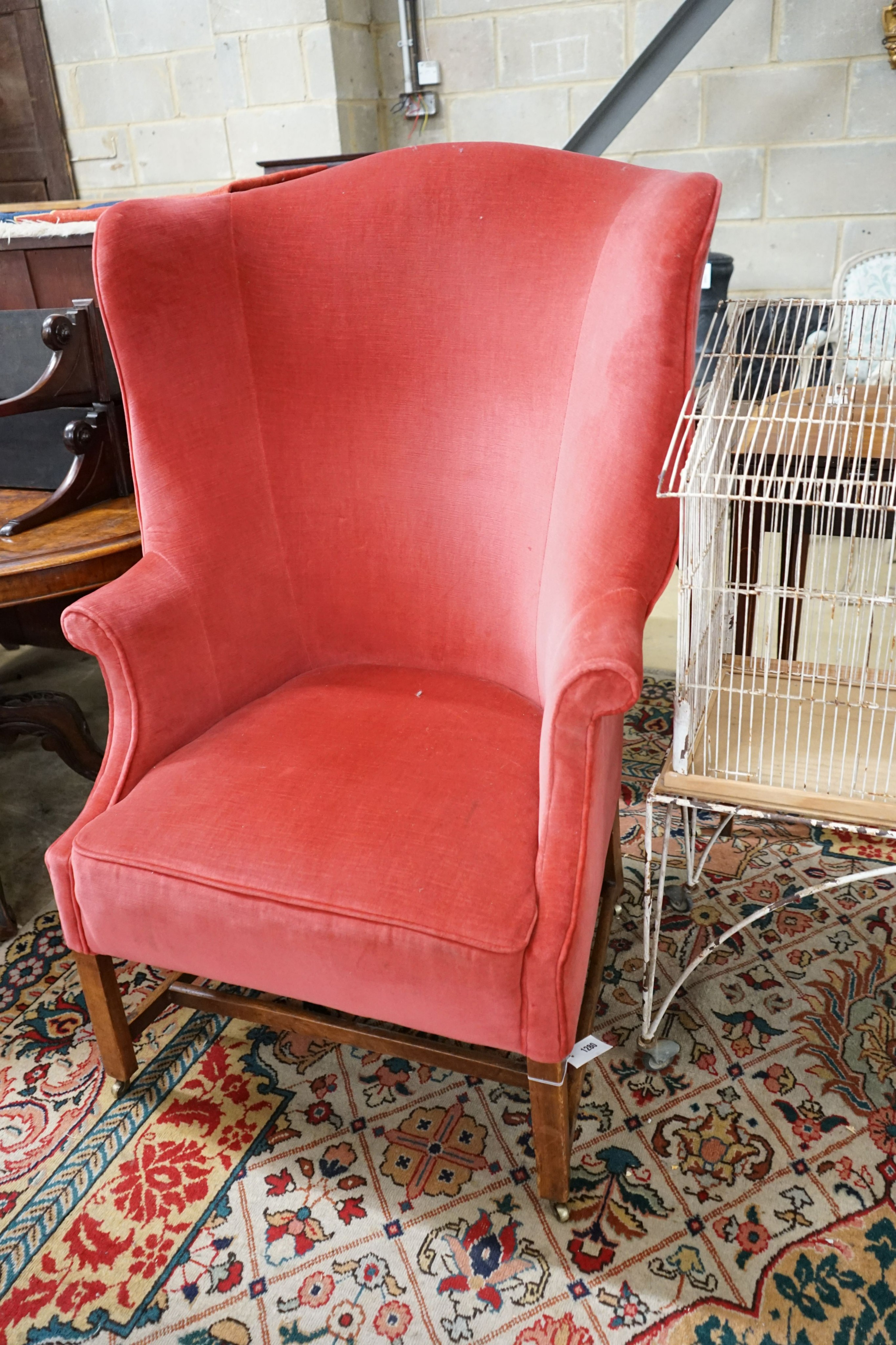 A George III provincial upholstered tub shaped armchair, width 76cm, depth 58cm, height 120cm